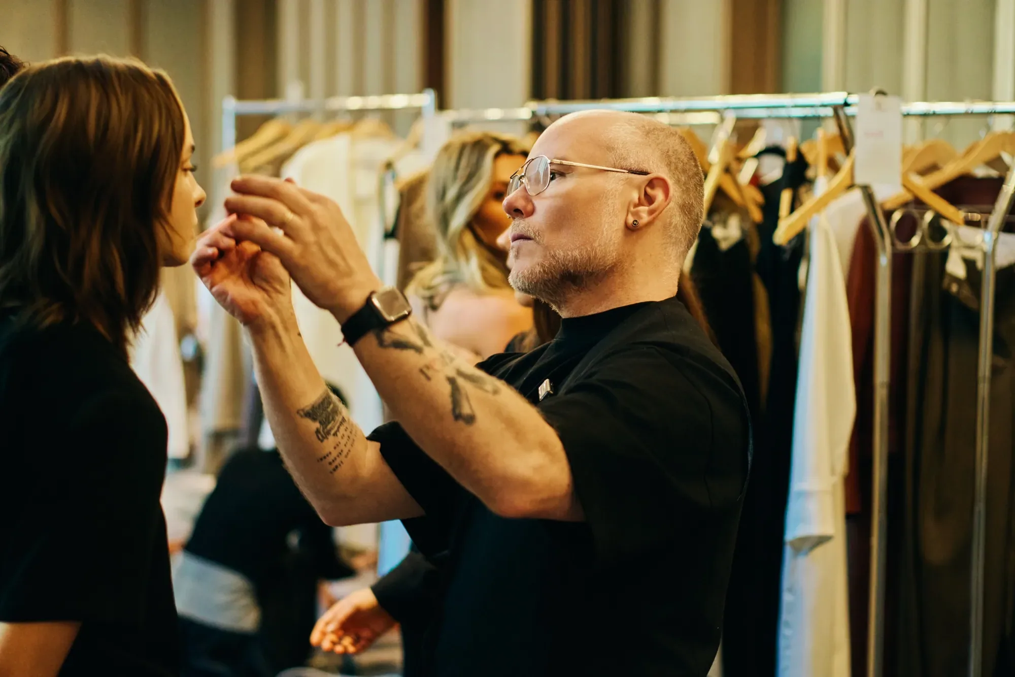 Aubrey styling a model backstage at fashion week