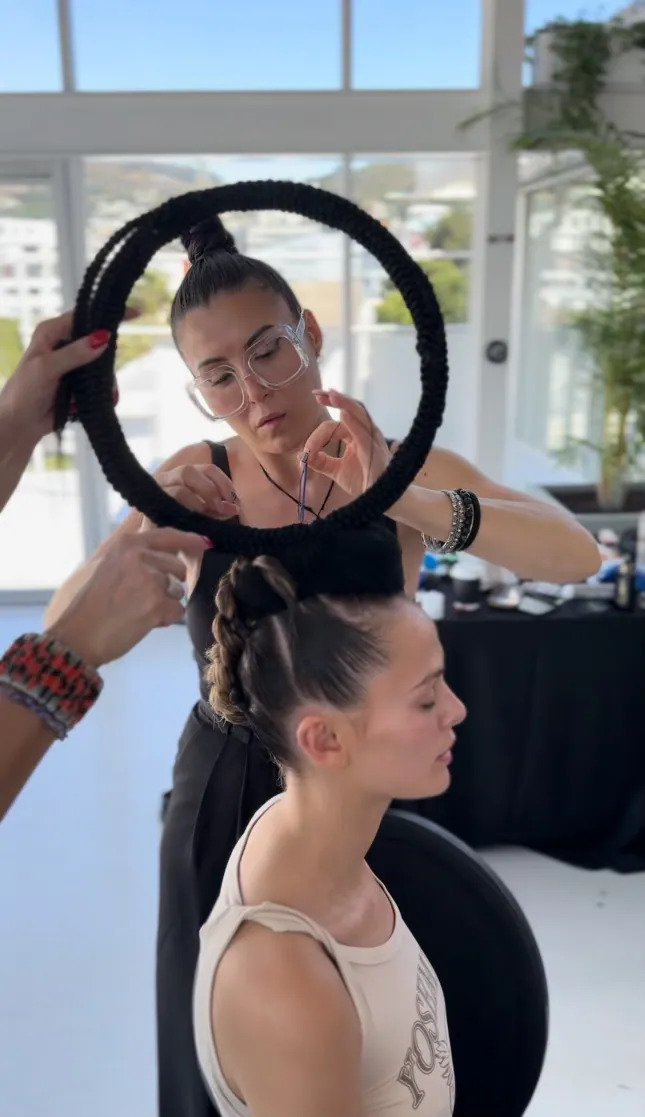 Stylist working with a ring light backstage
